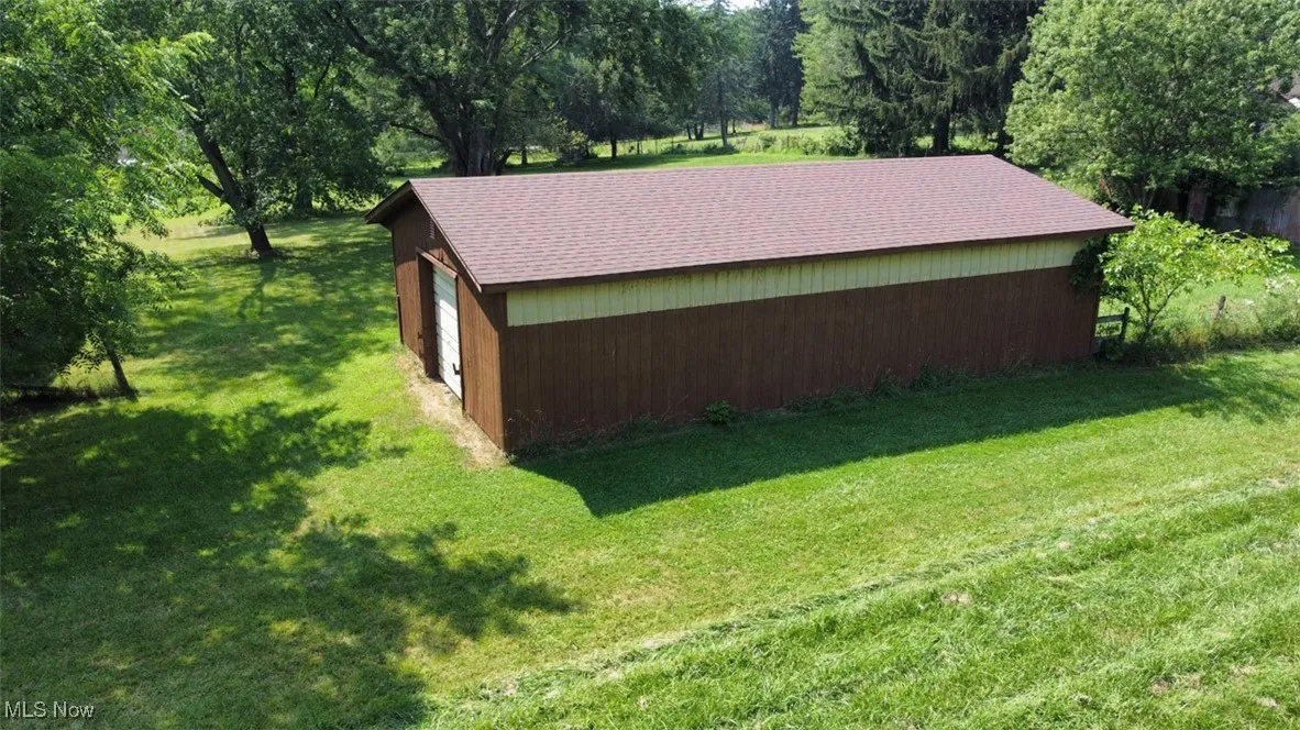 View of an outdoor structure and a yard