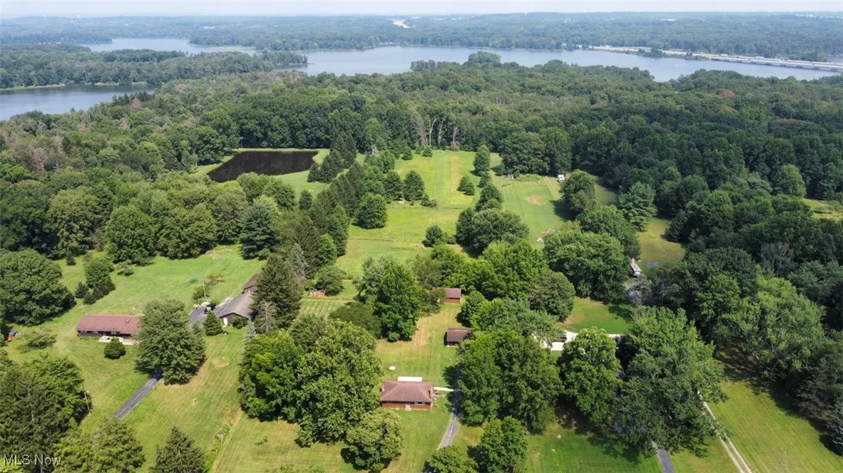 Aerial view of a heavily wooded area and a nearby body of water