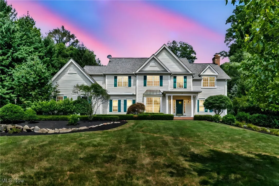 Traditional-style home featuring a yard and a chimney