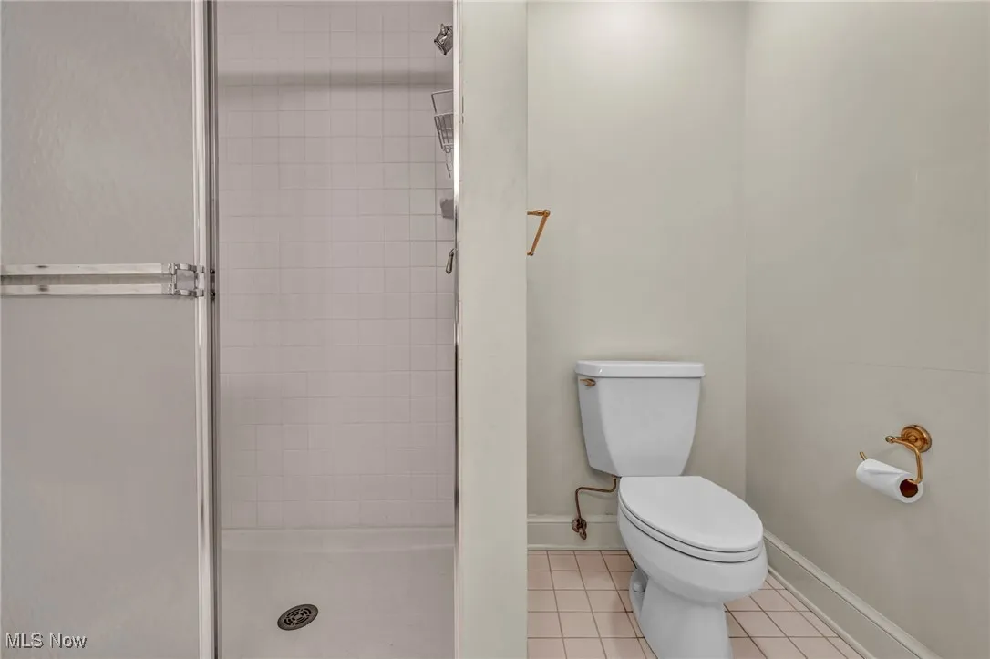 Bathroom featuring a stall shower and tile patterned flooring