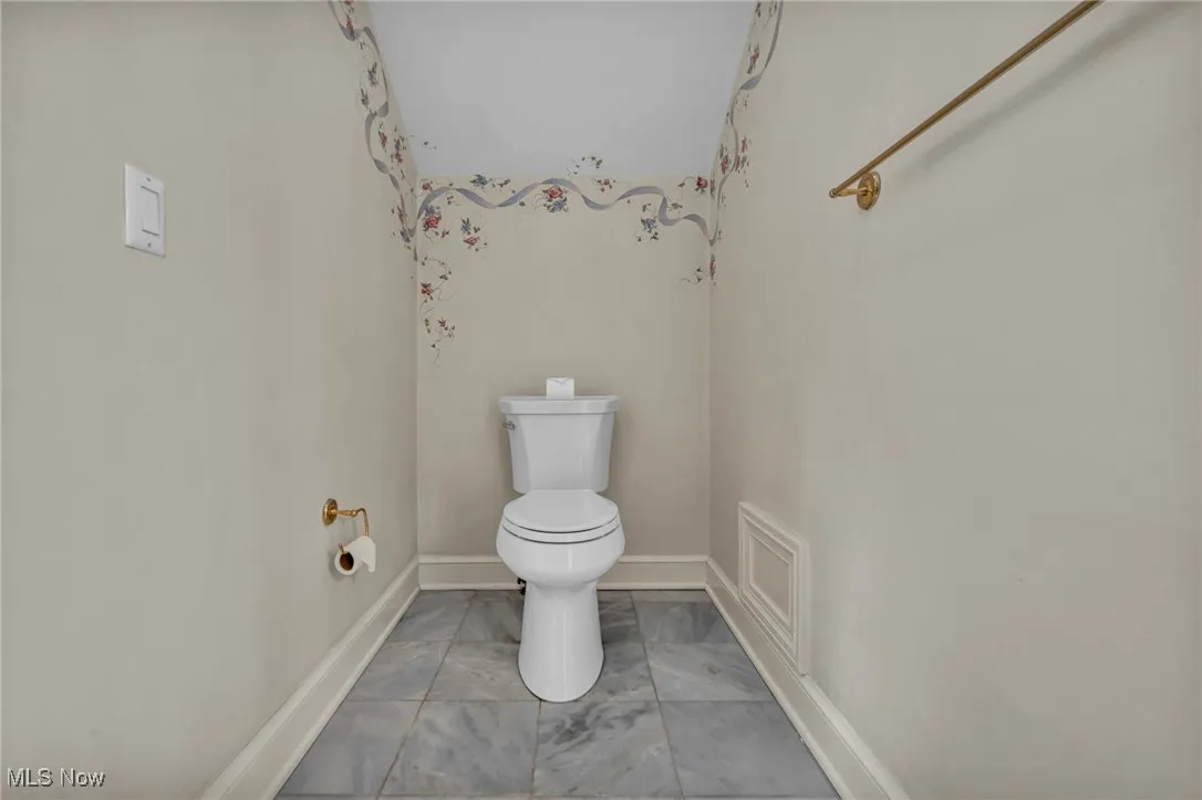 Bathroom with toilet and baseboards