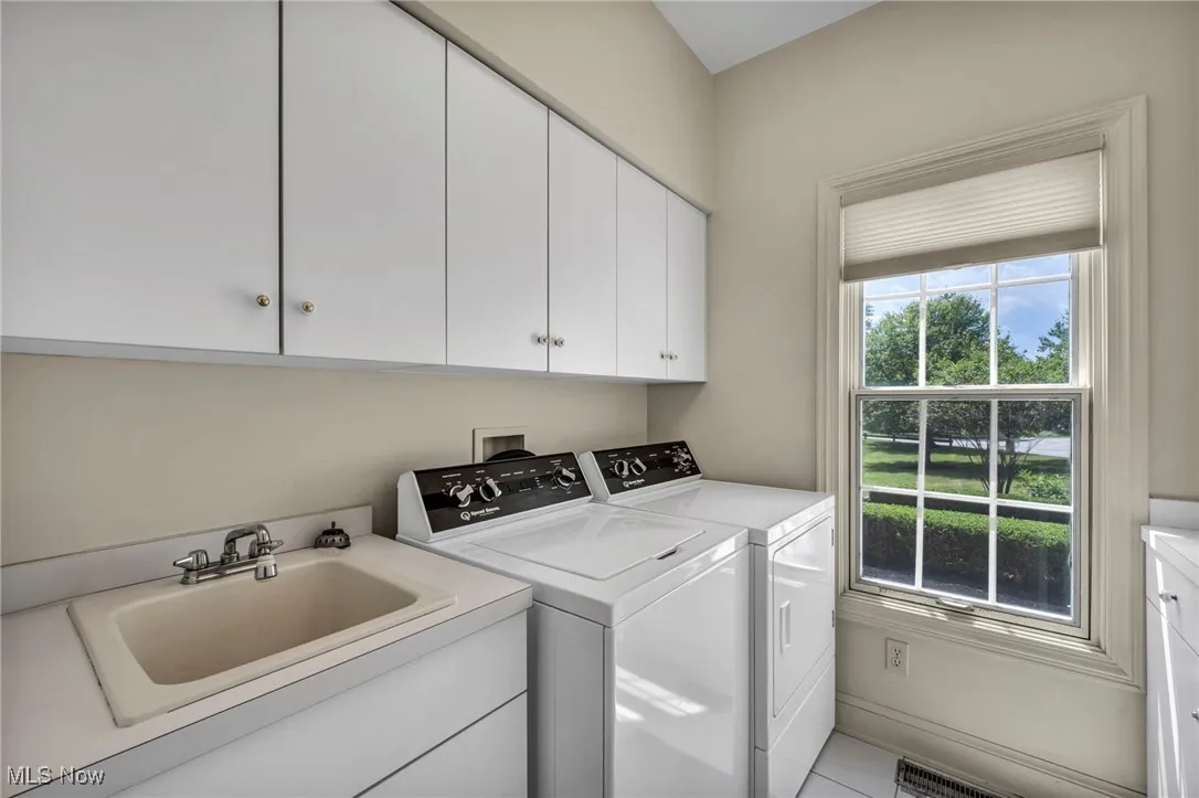 Laundry room featuring cabinet space and washing machine and clothes dryer