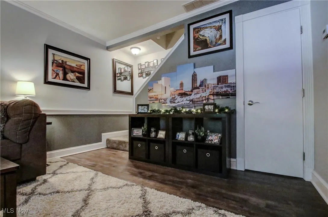 Office with crown molding and wood finished floors