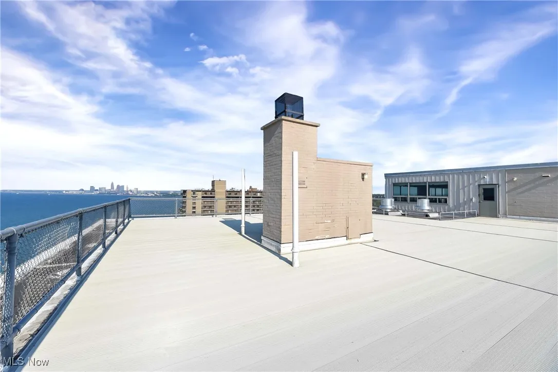 View of patio / terrace with a view of city and a water view
