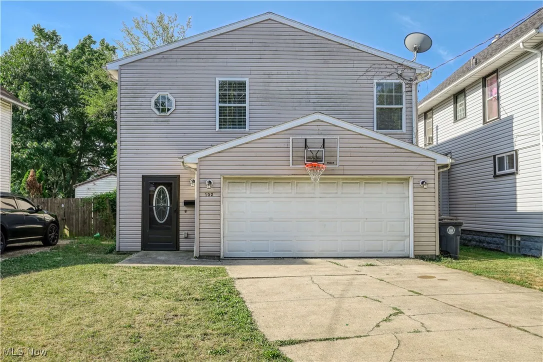 Traditional home featuring concrete driveway