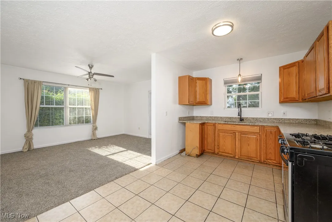 Kitchen featuring granite counters, new sink and lighting