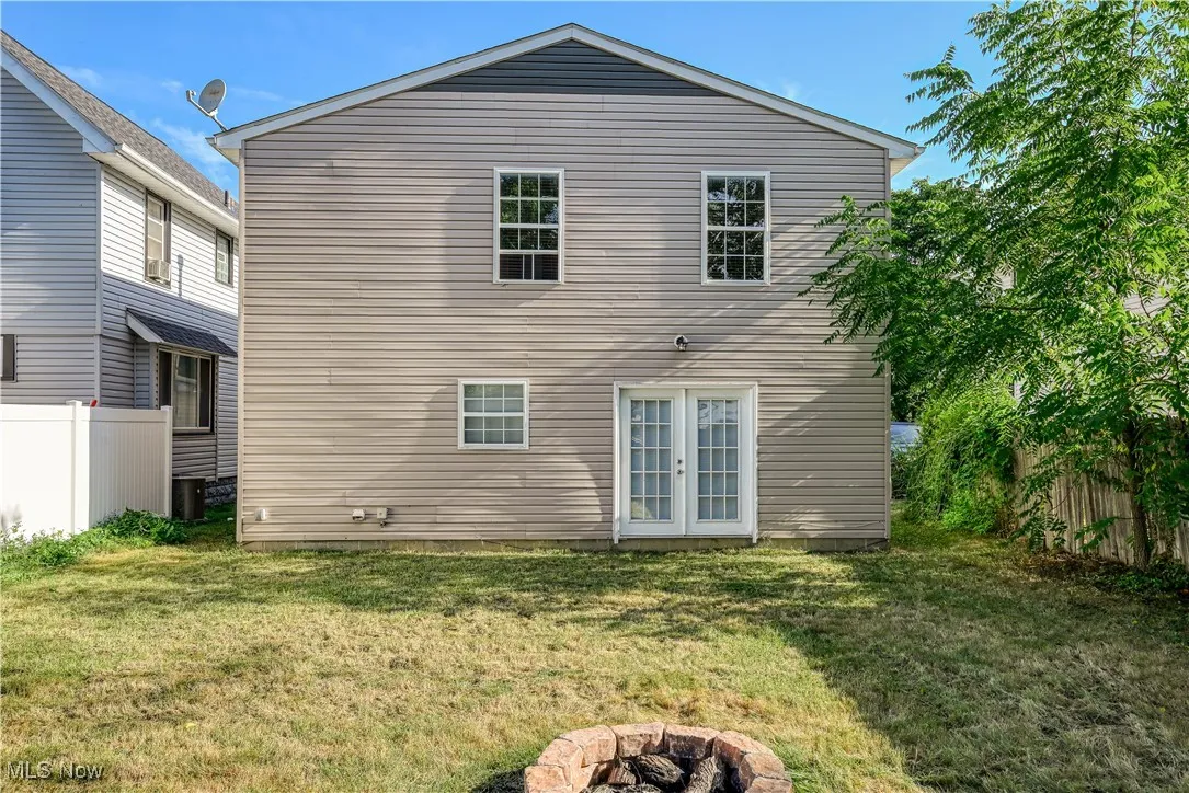 Back of house featuring a fire pit