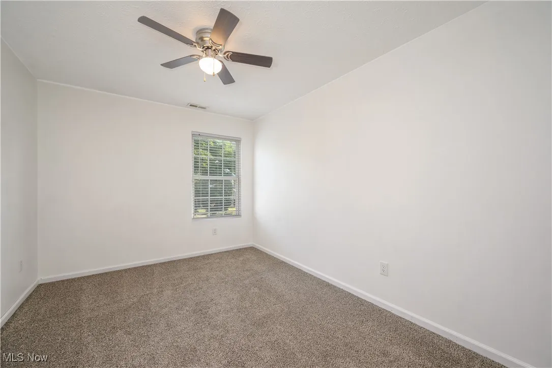 Bedroom with carpet floors and a ceiling fan