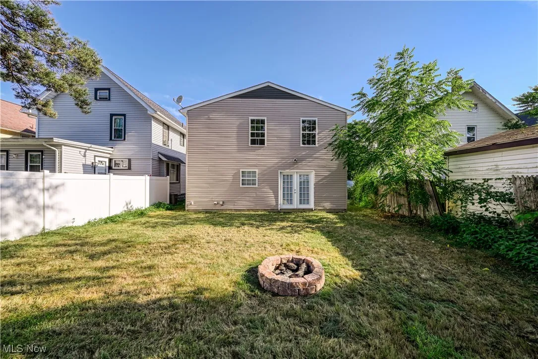 Rear view of property featuring french doors and a fire pit
