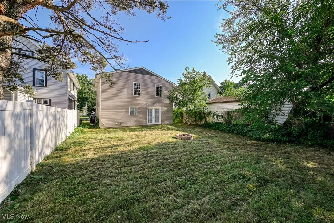 Rear view of house featuring french doors and an outdoor fire pit