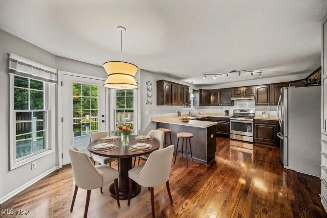 Kitchen/dining area leading out to backyard deck. Virtually staged.