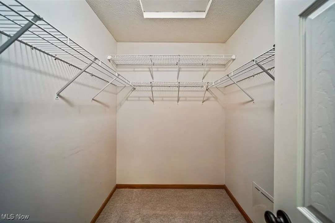 Walk in closet in primary bedroom.