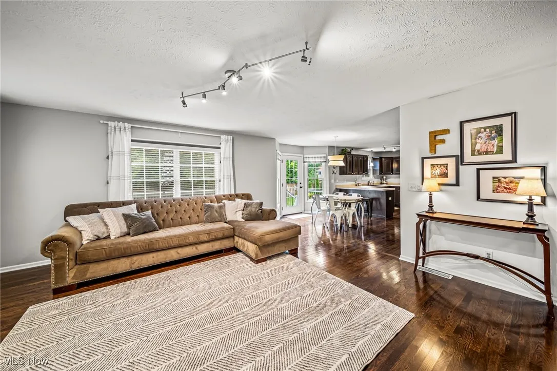 Featuring wood floors, track lighting, and large window.