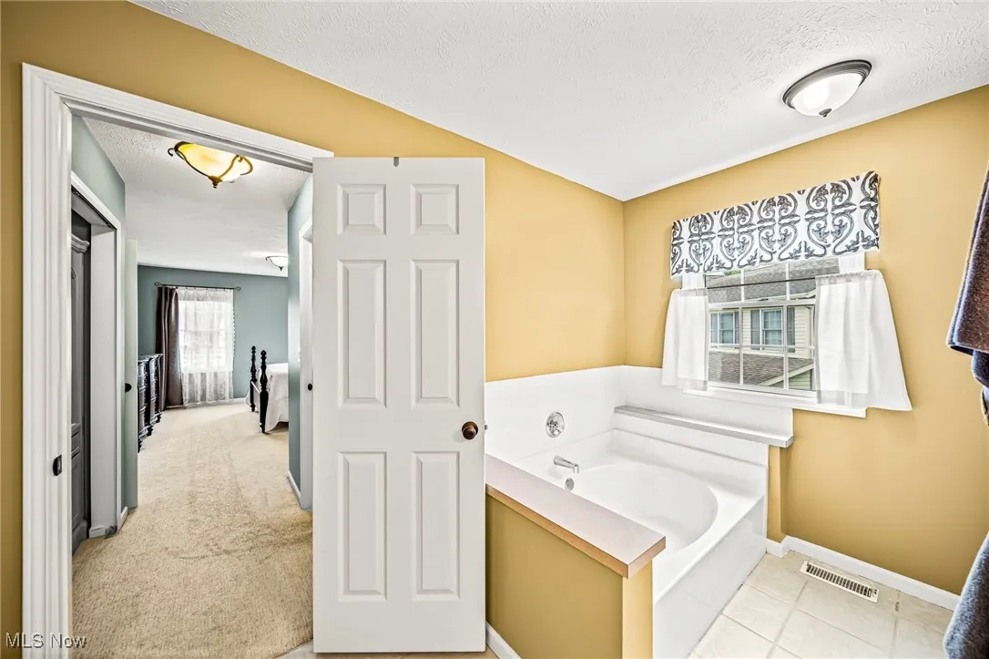 Primary bathroom with separate soaking tub.