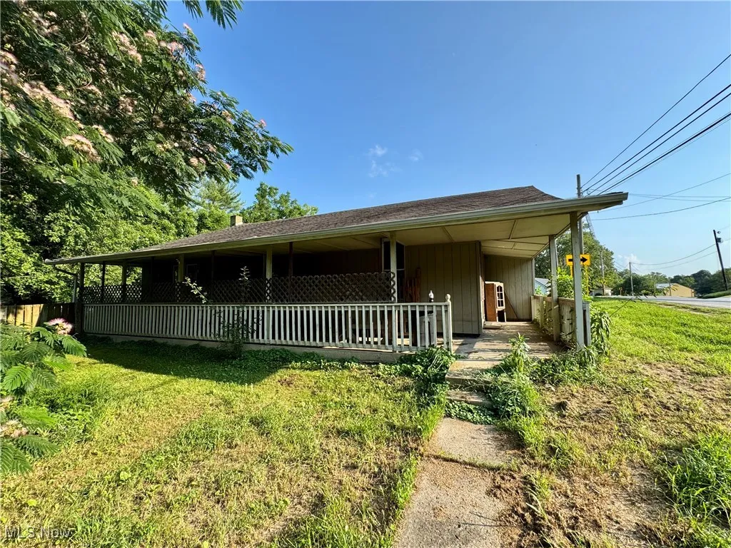 View of front of home with a front lawn and a porch