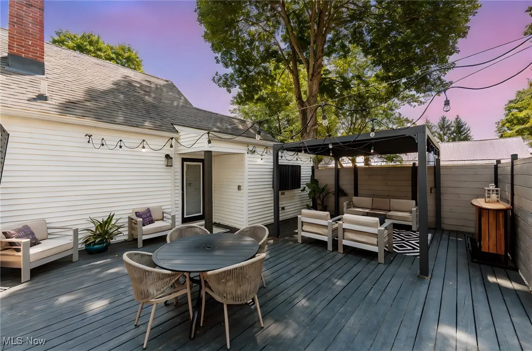 Deck at dusk with an outdoor hangout area and a gazebo