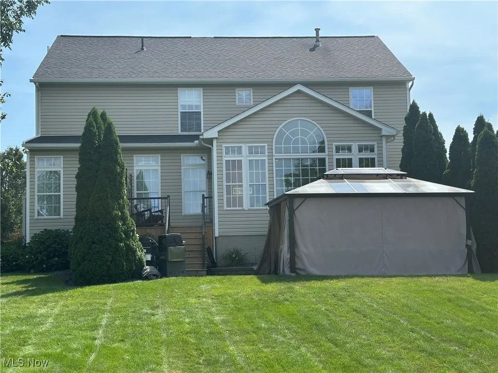 Rear view of house featuring a lawn
