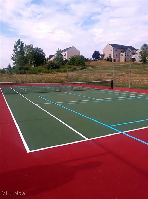 View of tennis court with community basketball court
