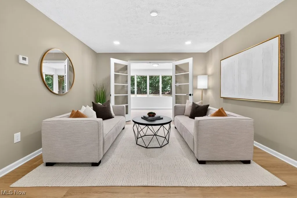 Living area featuring a textured ceiling, wood finished floors, and recessed lighting
