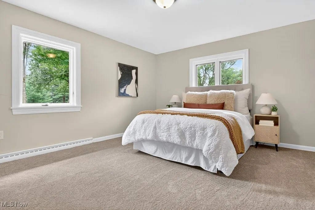Main en-suite bedroom with baseboards and a baseboard heating unit
