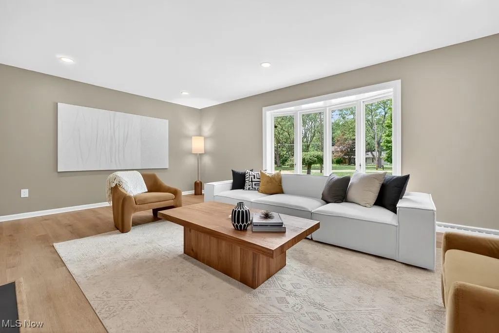 Living room with recessed lighting and light wood-type flooring