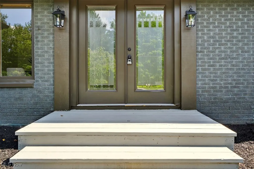 Entrance to property with brick siding and french doors