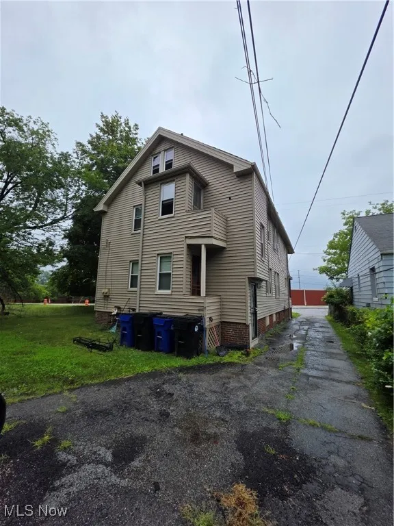 Rear view of house featuring a yard