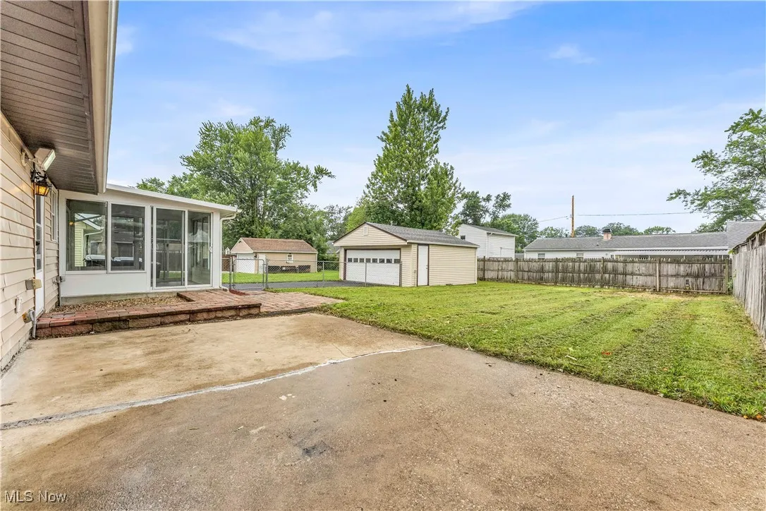 Fenced backyard, patio, and garage.