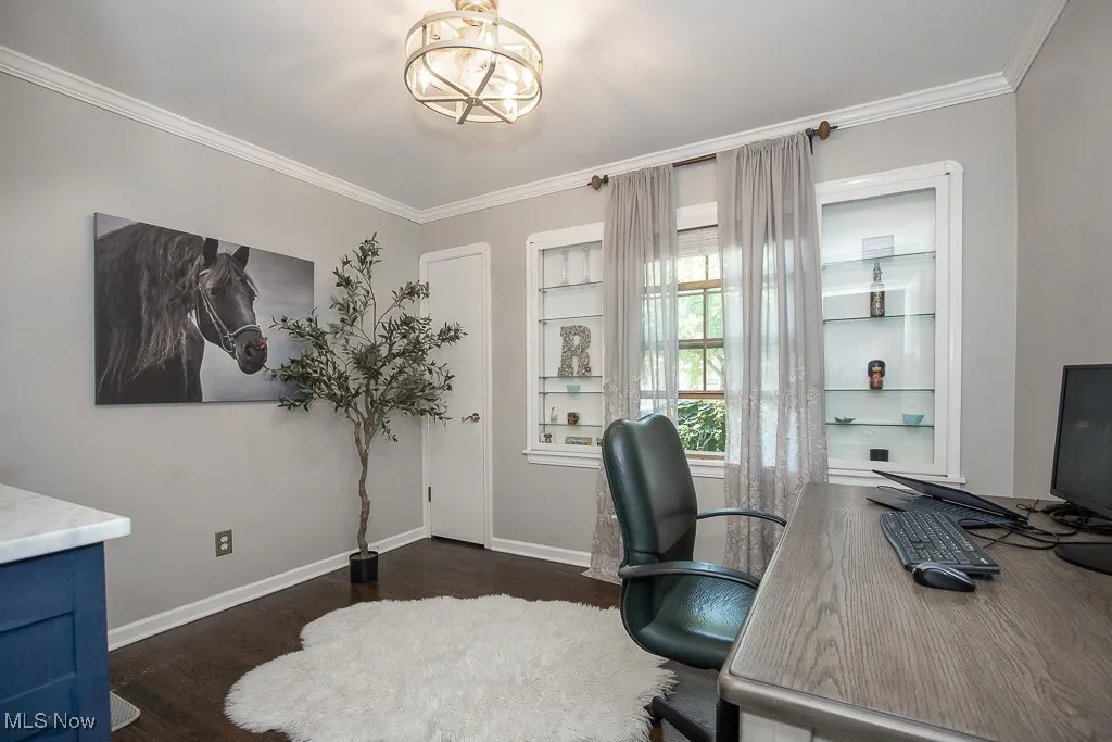 Office space with crown molding, wood finished floors, and a chandelier