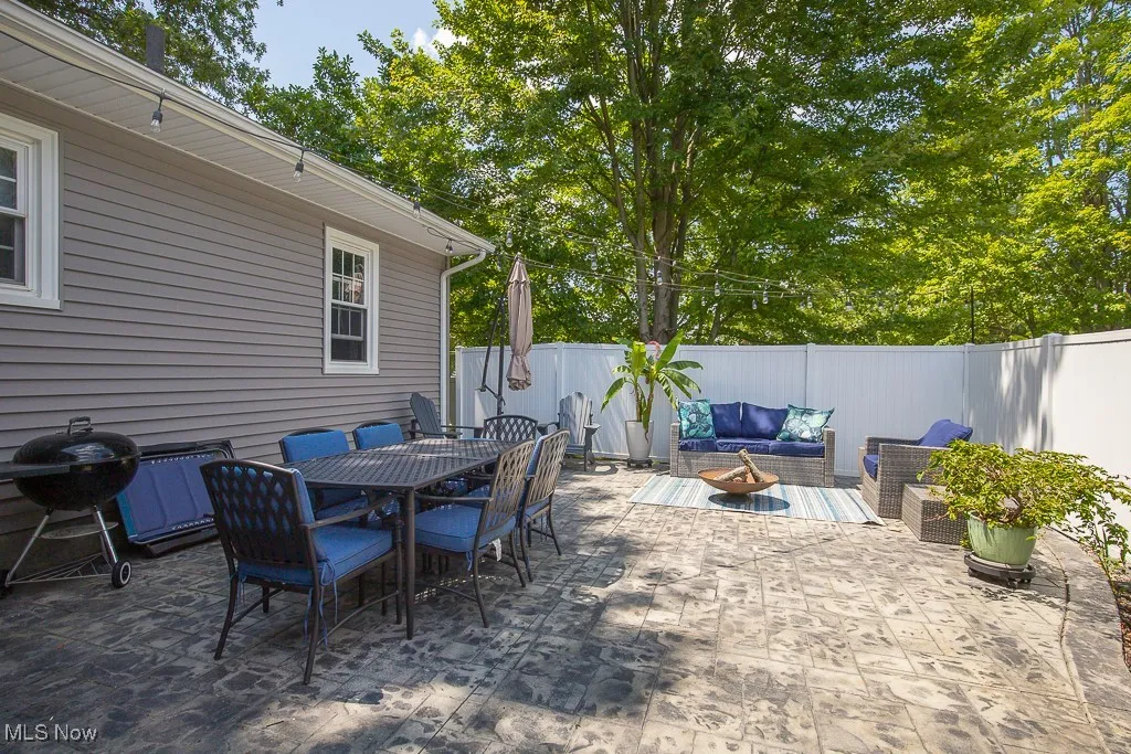 Fenced backyard featuring an outdoor living space, grilling area, a patio, and outdoor dining space