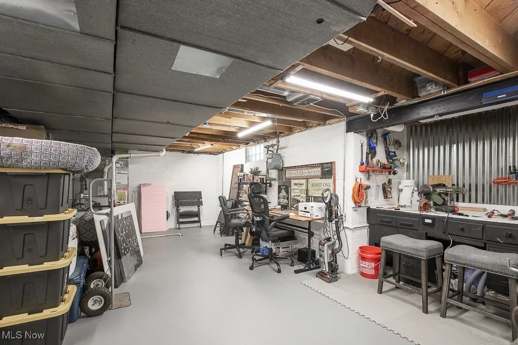Unfinished below grade area featuring a workshop area