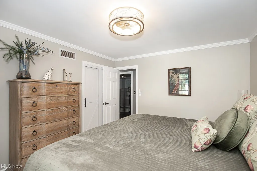Bedroom featuring ornamental molding and a closet
