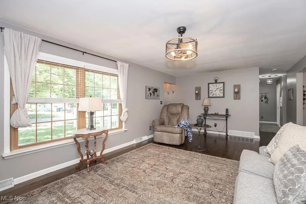 Living area with baseboards and wood finished floors