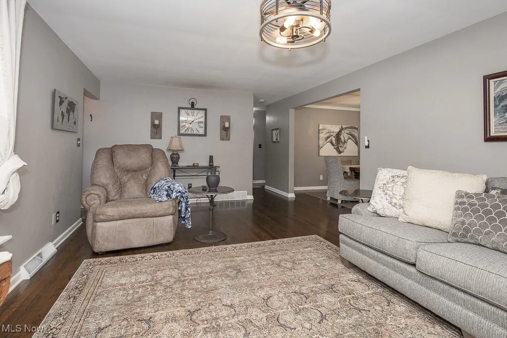 Living area with wood finished floors and baseboards