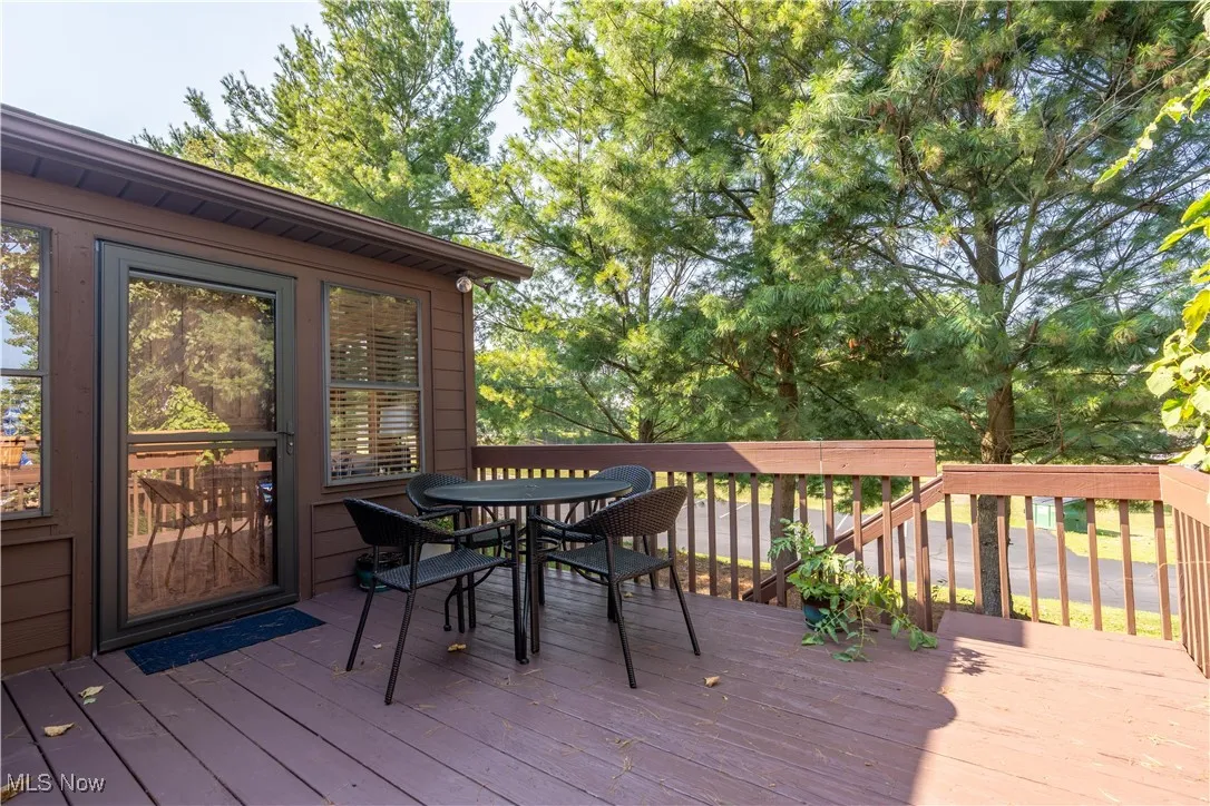 Wooden deck featuring outdoor dining area