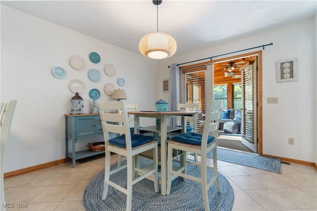 Dining area featuring baseboards and light tile patterned floors