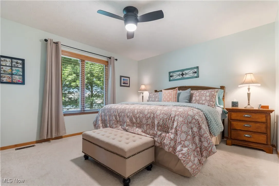 Bedroom featuring light colored carpet and ceiling fan