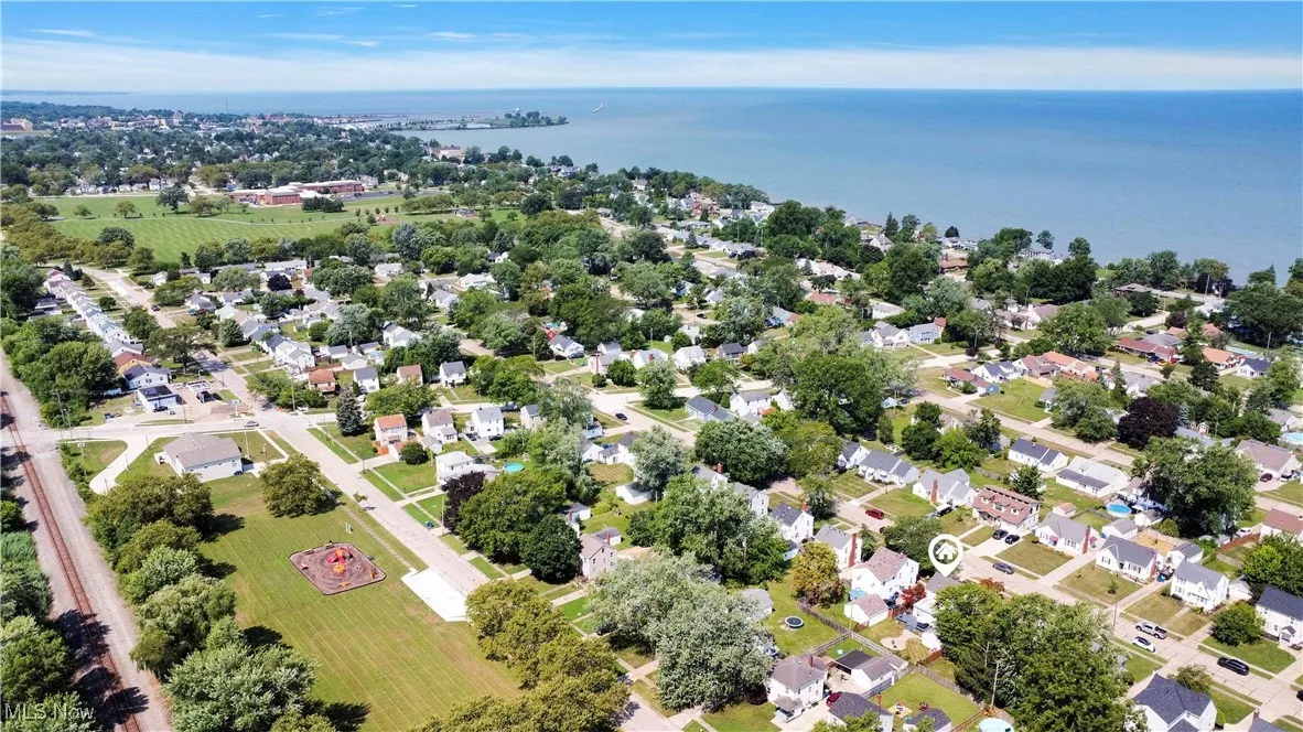 Aerial perspective of suburban area with a nearby body of water
