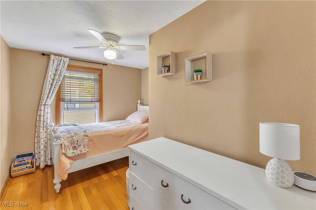 Bedroom with light wood-style floors and ceiling fan