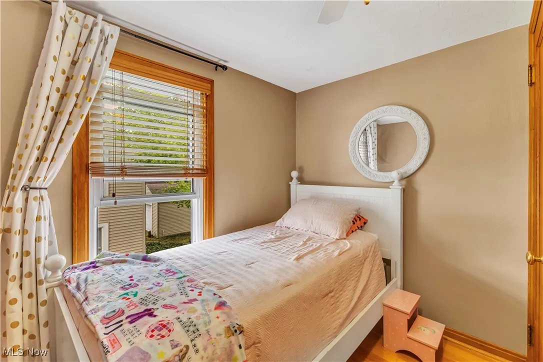Bedroom with a ceiling fan and wood finished floors