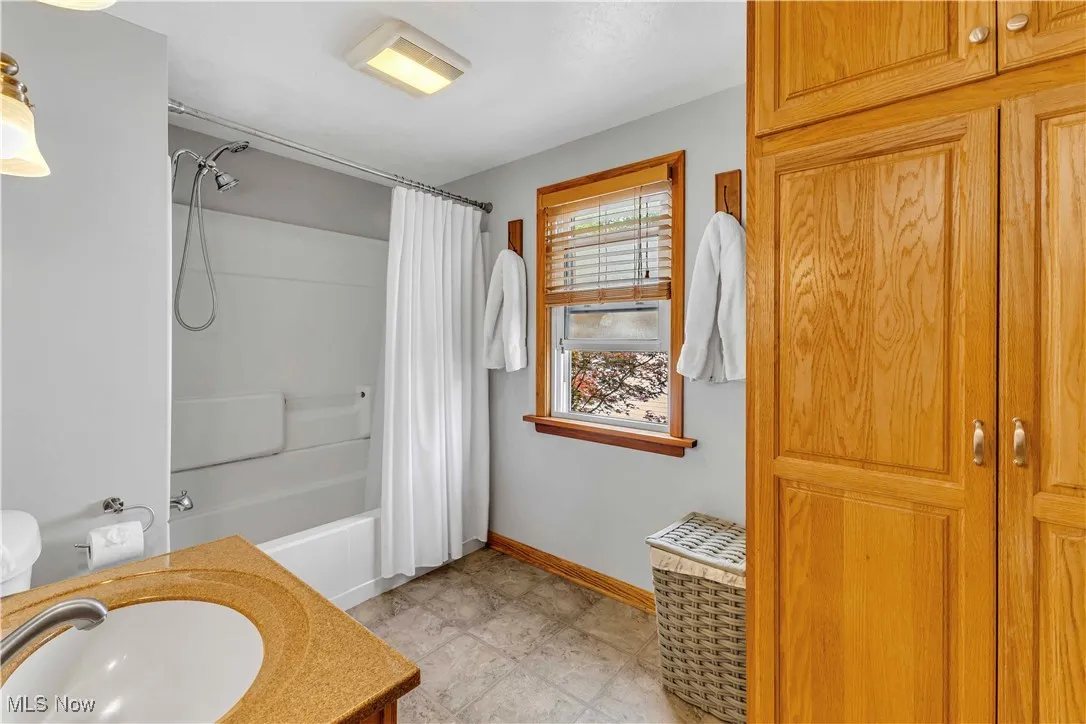 Bathroom with vanity and shower / bath combo
