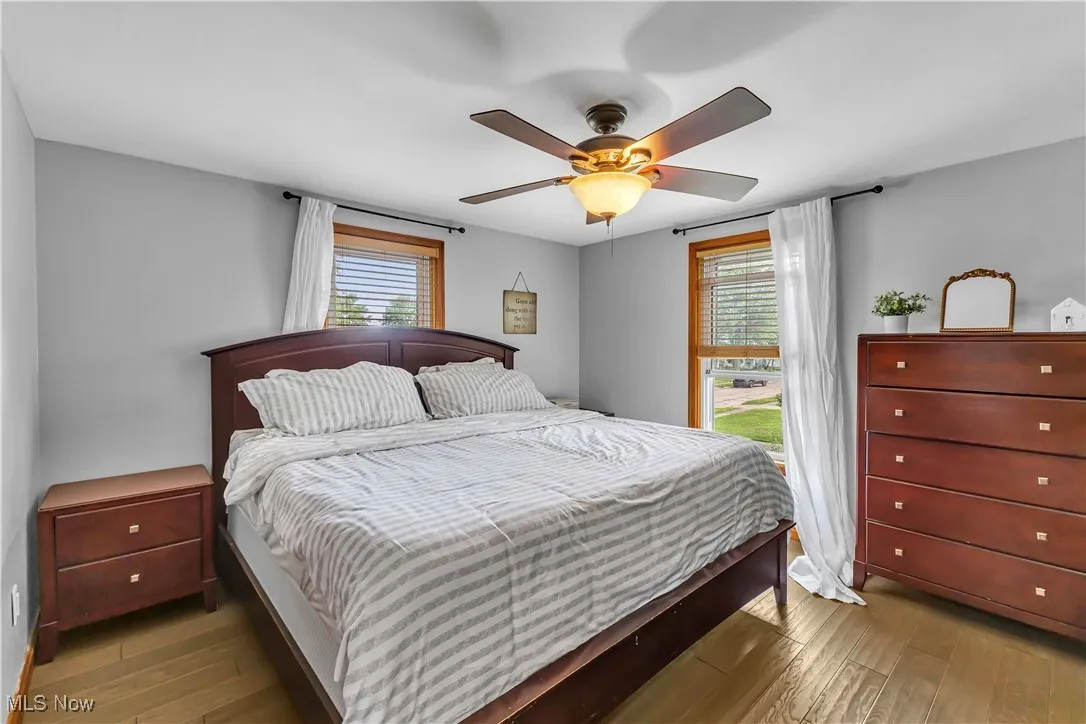 Bedroom featuring wood finished floors and a ceiling fan