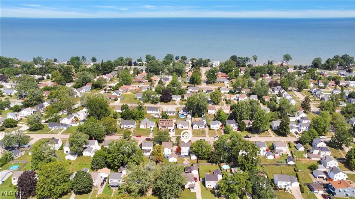 Aerial perspective of suburban area with a nearby body of water