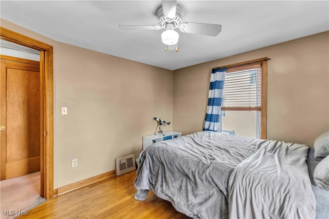 Bedroom with light wood finished floors and ceiling fan