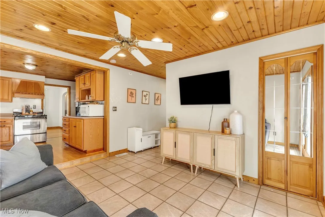Living area featuring recessed lighting, wood ceiling, light tile patterned floors, and ceiling fan