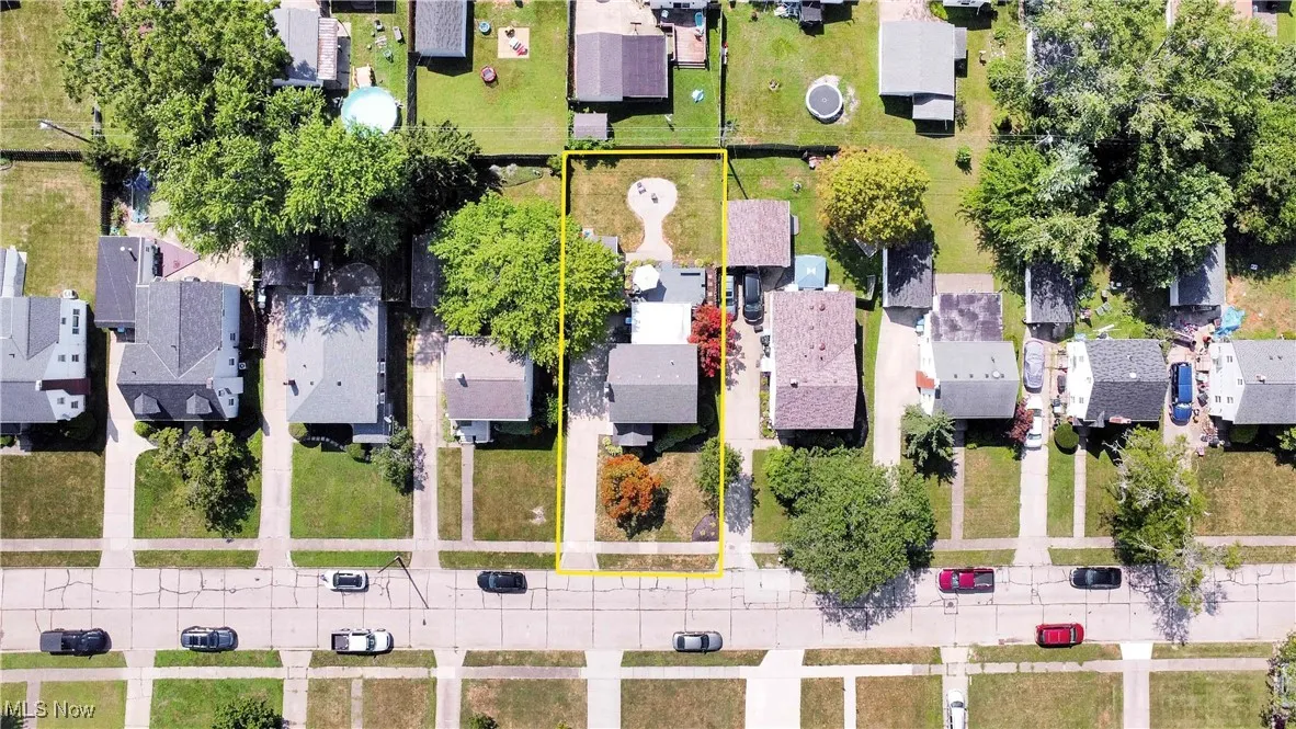 Aerial perspective of suburban area featuring property boundaries highlighted