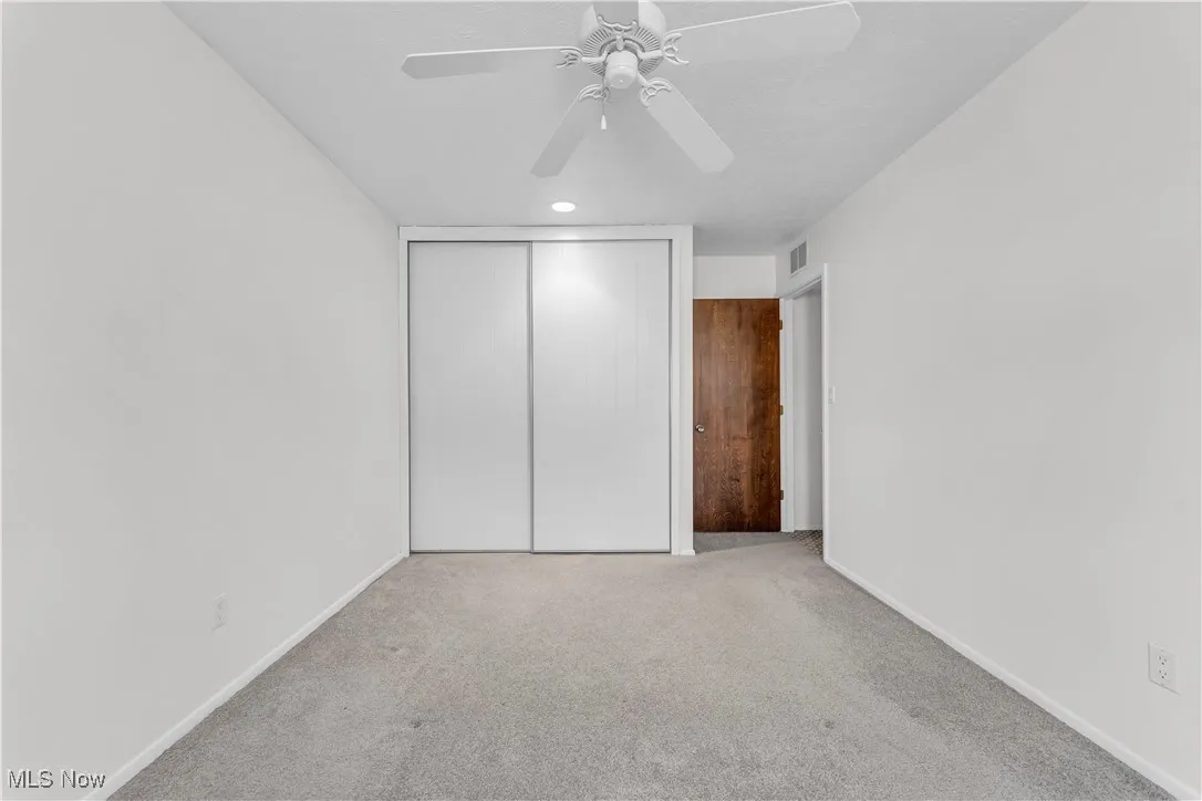 Unfurnished bedroom featuring carpet, a closet, recessed lighting, and ceiling fan