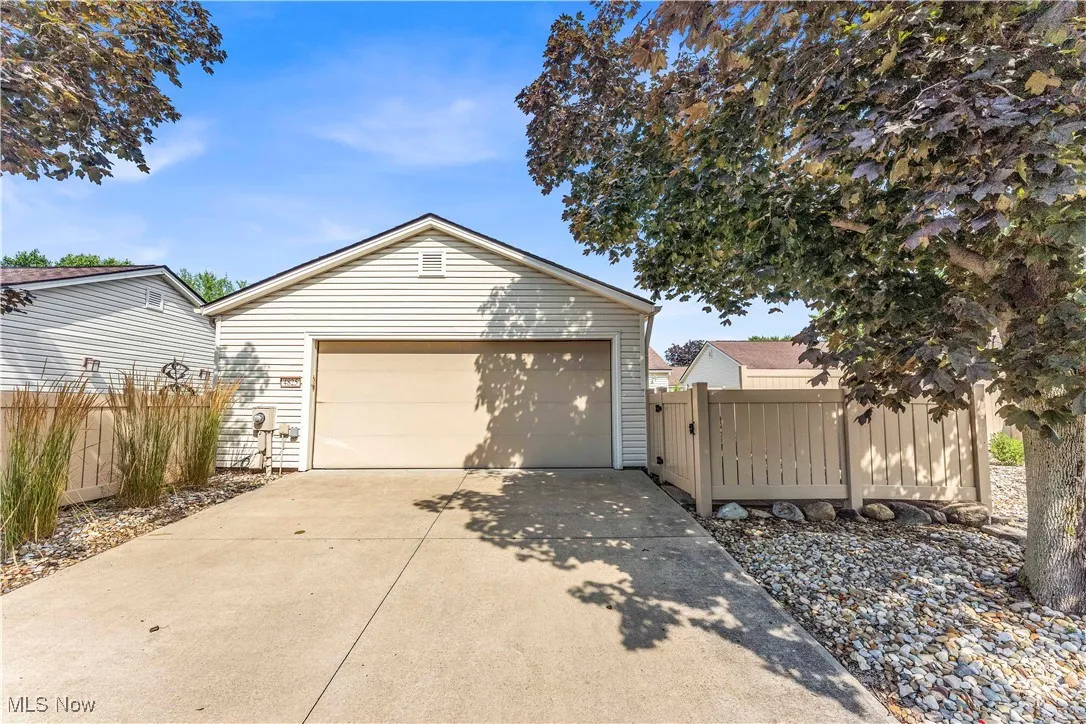 Garage featuring concrete driveway