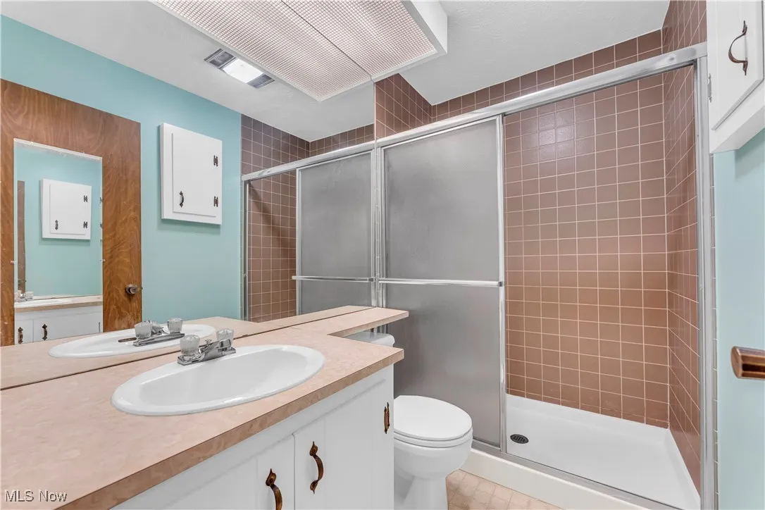 Bathroom with a stall shower and vanity