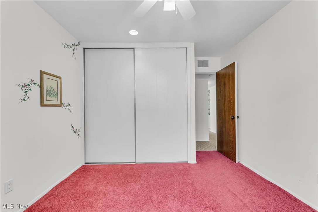 Unfurnished bedroom featuring a closet, carpet, a ceiling fan, and recessed lighting